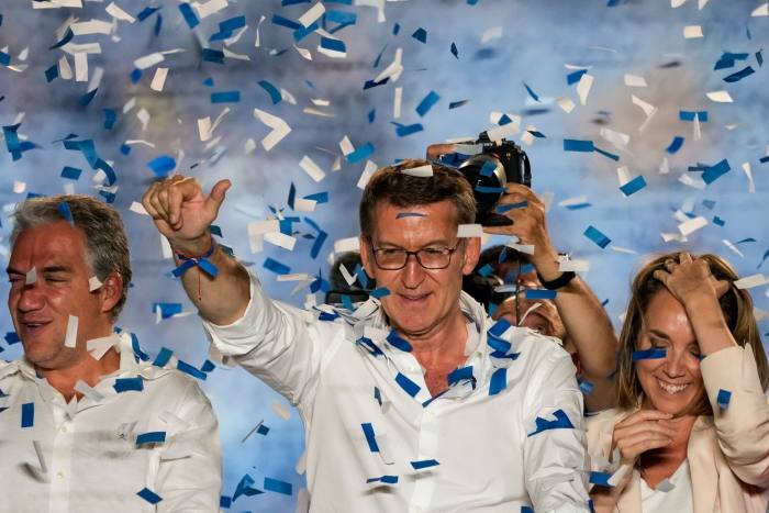 People’s party leade rAlberto Núñez Feijóo, centre, waves during an election night rally in Madrid on Sunday