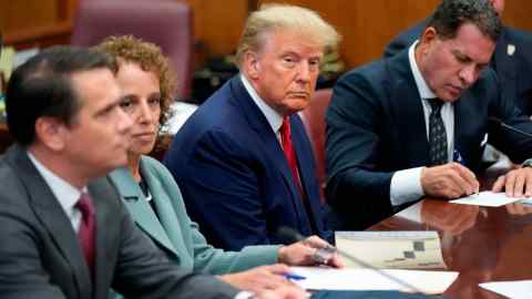 Donald Trump sits with his defence team in a Manhattan court earlier this week