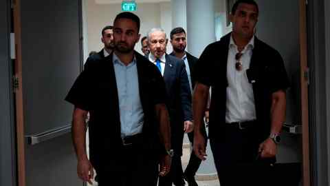 Benjamin Netanyahu surrounded by security people